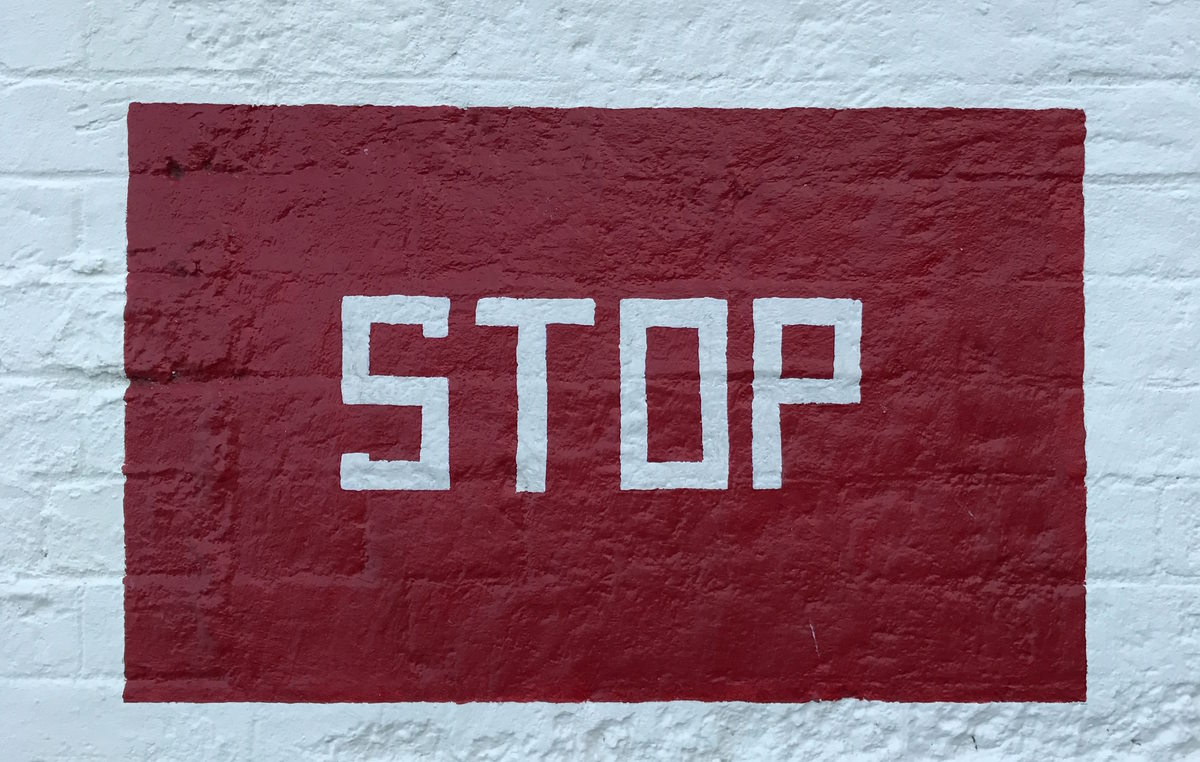 "Stop" painted on a wall